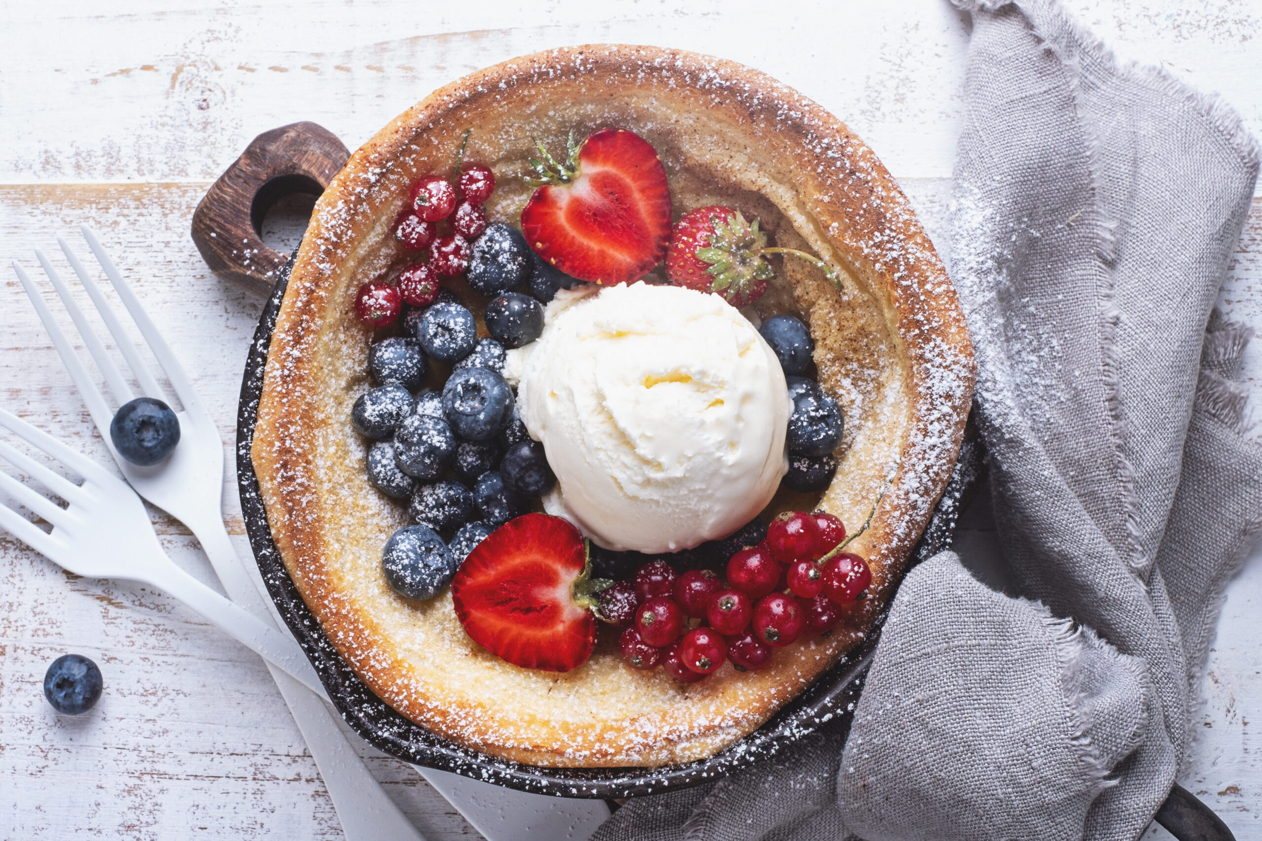 A Dutch pancake topped with fresh berries and home made cream — a sweet highlight from Somebody Feed Phil Amsterdam.