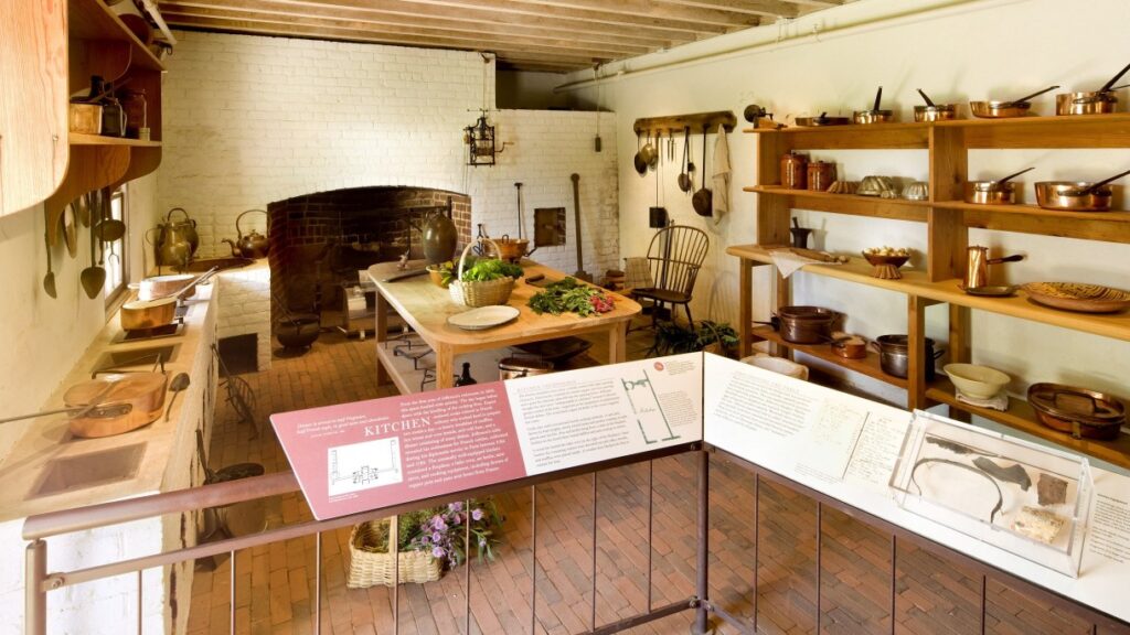 Monticello kitchen interior with colonial-era pots, shelves, and stove — showcasing the tools used by James Hemings and central to Virginia African American food roots.
