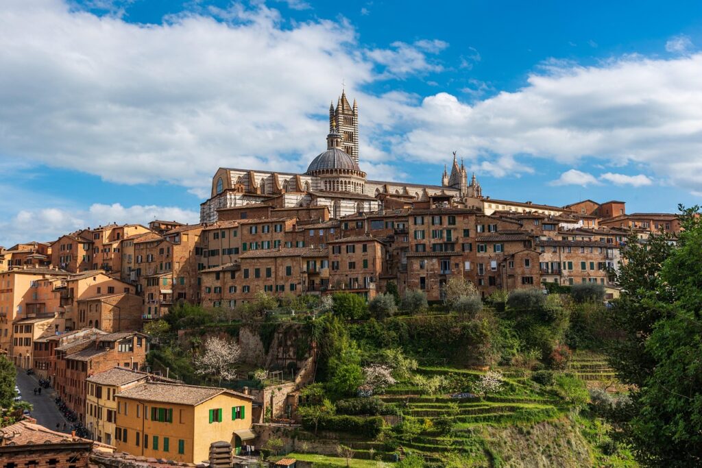 Scenic view of Siena in Tuscany, featuring the iconic cathedral and hillside buildings, as seen in Stanley Tucci’s Tuscany episode exploring traditional Italian food culture.