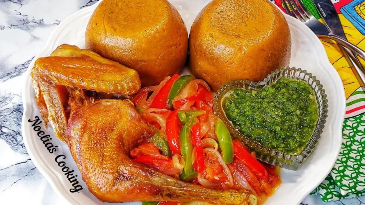 Amiwo served with grilled chicken, sautéed peppers, and green sauce — a traditional Beninese dish showcasing Benin African American food roots.