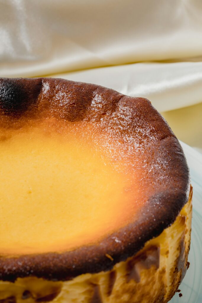 Close-up of a creamy Basque cheesecake with its signature burnt top, a dessert made famous in Somebody Feed Phil Basque Country.