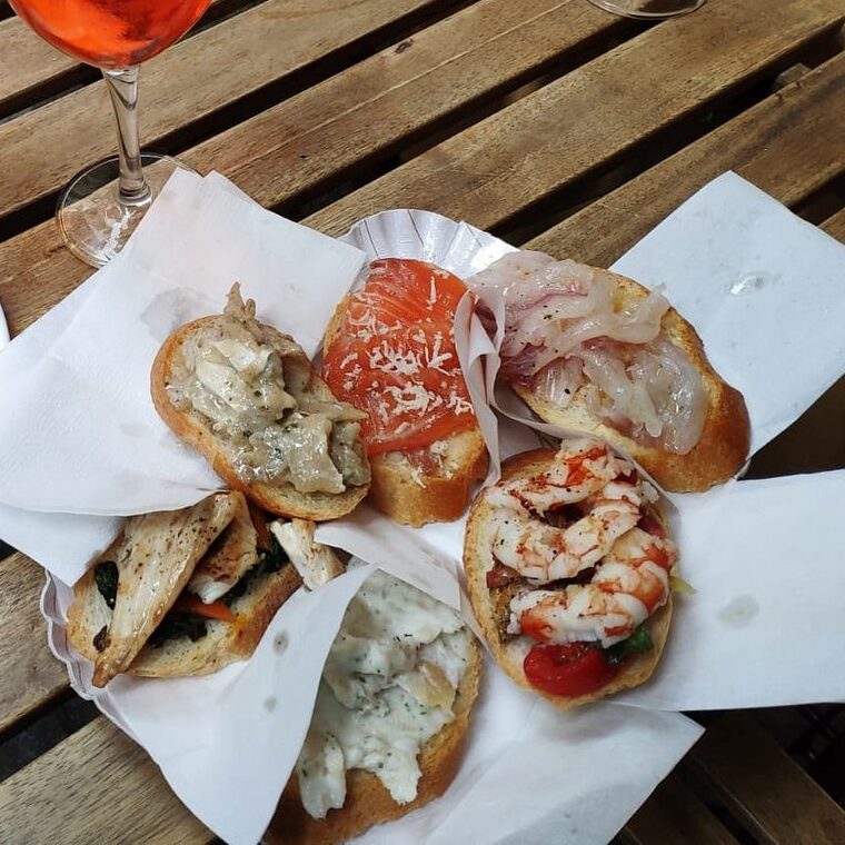Venetian assorted cicchetti with seafood, cured meats, and fresh toppings served in a traditional bacaro