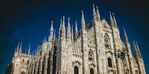 The Duomo di Milano under a clear blue sky — a symbol of Milan’s cultural richness featured in Stanley Tucci’s Italian food journey.