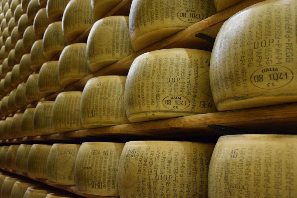 Aging Parmigiano Reggiano wheels in Emilia-Romagna—a taste of Bologna’s food legacy, as featured by Stanley Tucci.