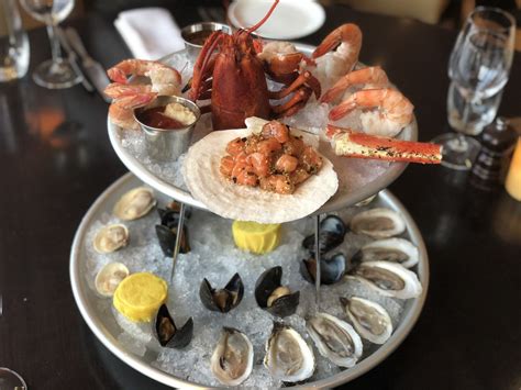 Layered seafood tower with oysters, shrimp, blue crab, and lobster at Neptune Oyster in Boston’s North End.