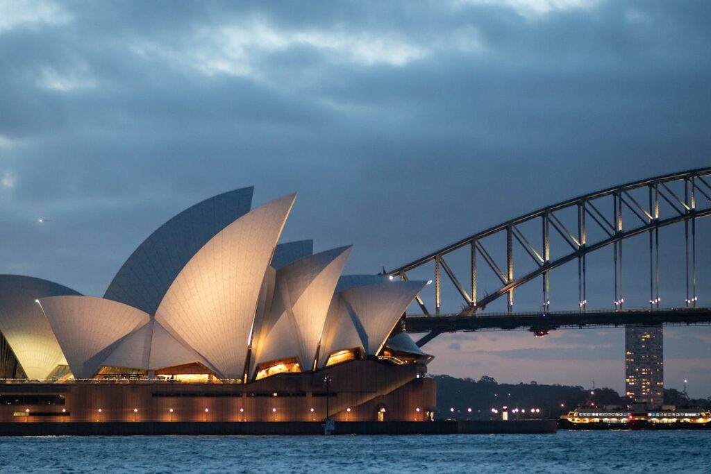 Sydney Opera House and Harbour Bridge at dusk — iconic landmarks featured in Somebody Feed Phil’s Sydney episode, Season 8.