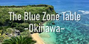 Okinawa coastline with turquoise waters and lush greenery, representing the longevity lifestyle of the Blue Zone.