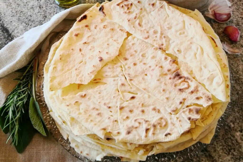 Traditional Sardinian pane carasau flatbread stacked on a plate 
