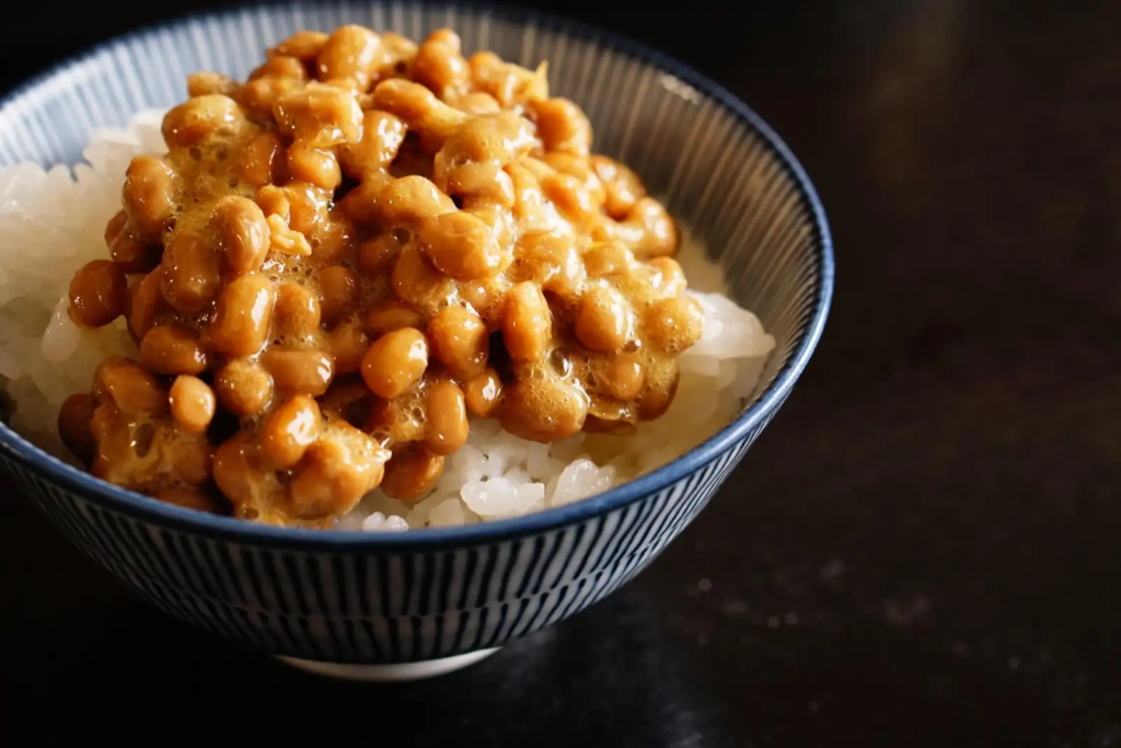 Bowl of sticky natto (fermented soybeans) served over rice, showcasing traditional Japanese probiotics