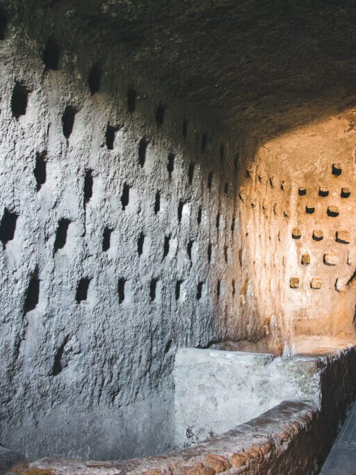 Ancient pigeon cave with carved nesting holes inside the Orvieto underground tunnel system, shown in Stanley Tucci Searching for Italy Umbria episode