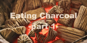 Burning charcoal glowing red inside a fire pit