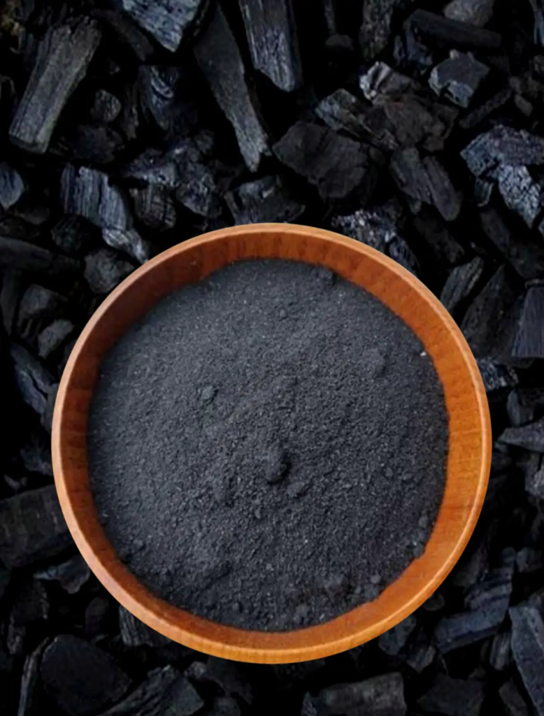 Wooden bowl filled with fine activated charcoal powder