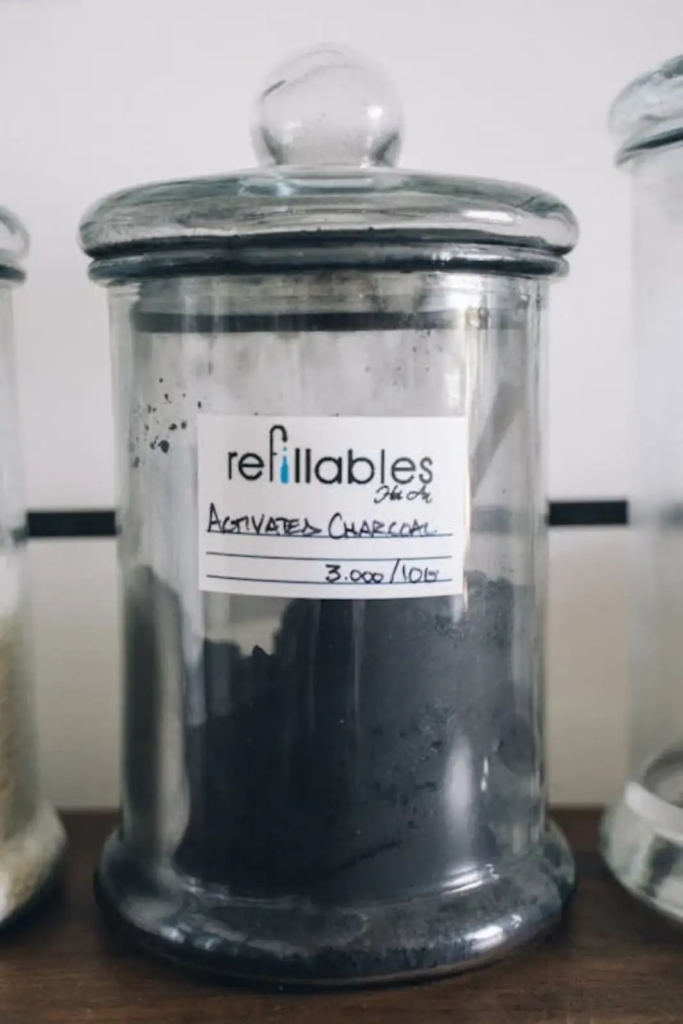 Glass jar filled with activated charcoal powder