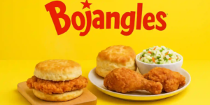 Bojangles logo on a bright yellow background above a Cajun chicken biscuit, plain biscuit, coleslaw, and fried chicken.