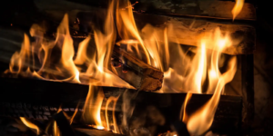 Bright orange and yellow flames from a wood fire.