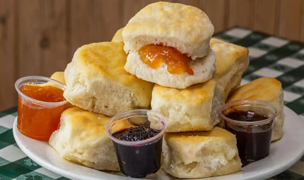 Loveless Cafe, Nashville—stack of buttermilk biscuits with cups of peach and blackberry preserves on a plate.