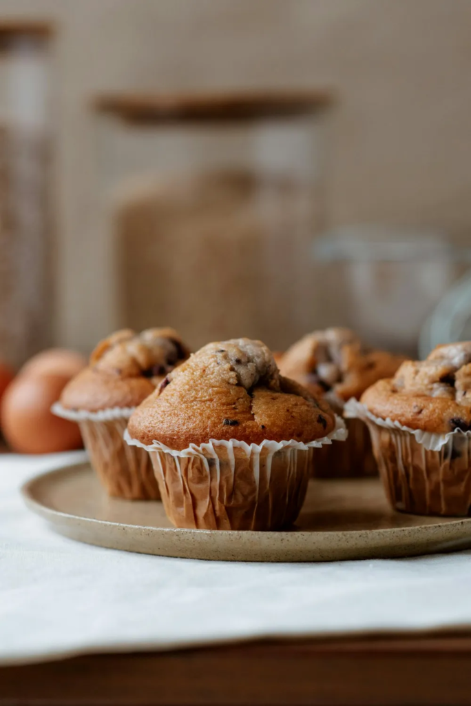 Golden muffins on a plate; classic example where baking powder gives a tall, even crumb.