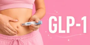 Woman injecting Wegovy into her stomach with large white GLP-1 text on a pink background.